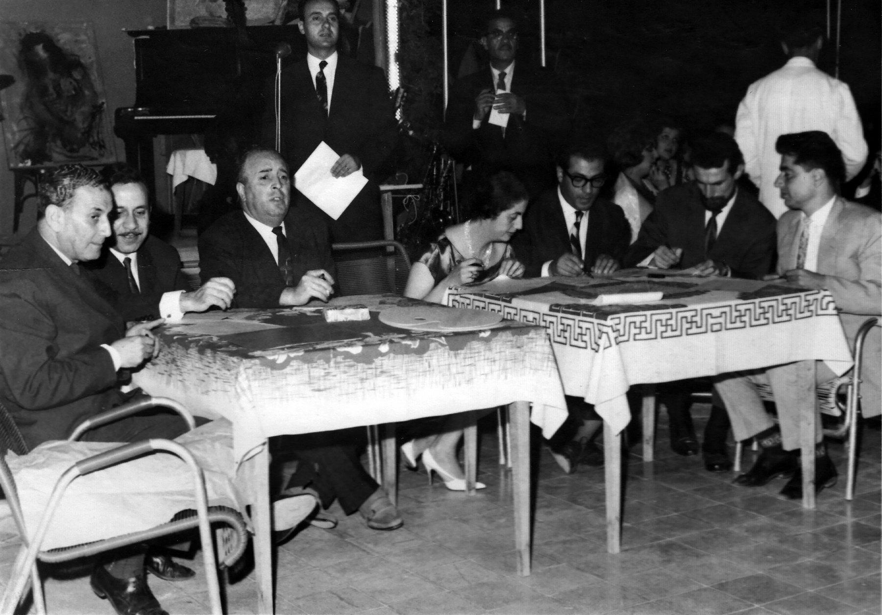 Jury supervising choosing&nbsp;artists&rsquo;&nbsp;muse&nbsp;at the Orient Club&nbsp;in Damascus, 20 July 1961. (from right) Naim Ismail (visual artist),&nbsp;Louay Kayyali (visual artist),&nbsp;Dr. Salman Kattaya (art critic),&nbsp;Derrie Fakhoury Hammad (female&nbsp;visual artist), Dr. Salim Adel Abdulhak (director of the Department of Archaeology and Museums),&nbsp;Dr. Afif Bahnassi&nbsp;(head of the Directorate of Visual Art&nbsp;at Ministry of Culture and National Guidance),&nbsp;Khaled Moaz (visual artist), and (back) Fadil Al-Siba&rsquo;I (novelist).
